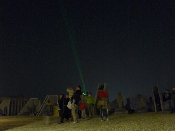 星空案内みちくさツアーの様子を撮影した写真。レーザー光で星を指し示しているところ。
